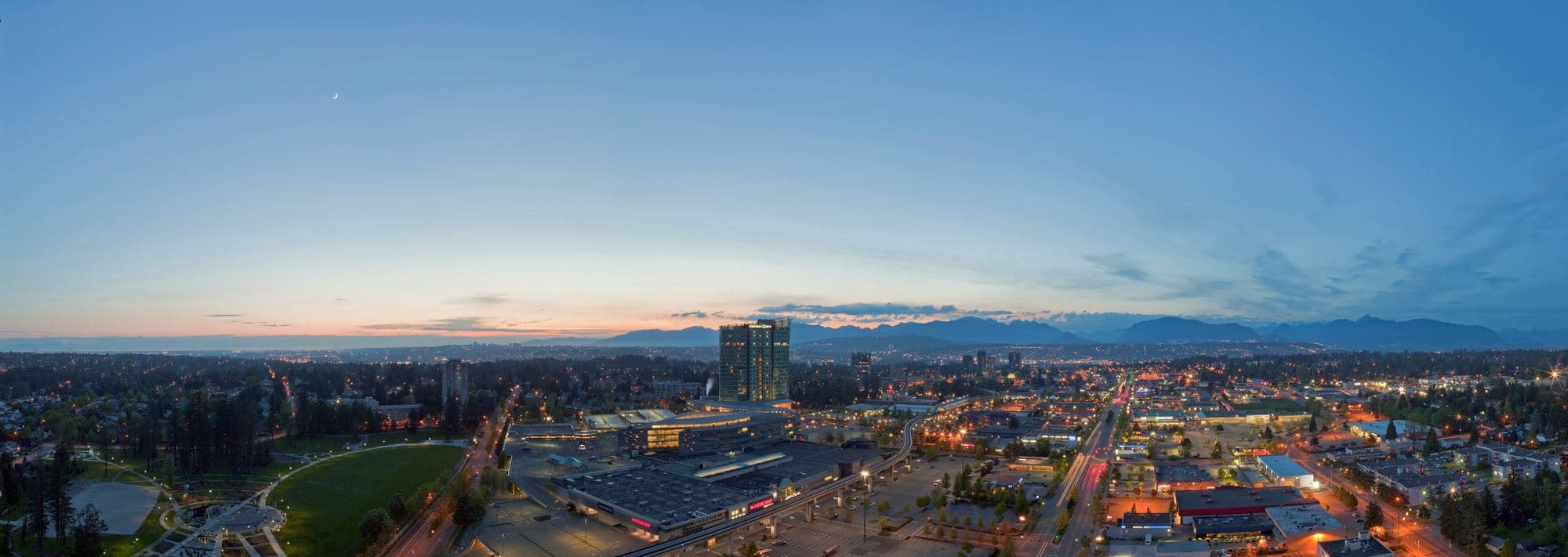 Surrey city centre at dusk, the North Shore mountains beyond